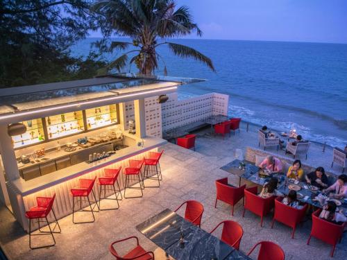 a restaurant with a view of the ocean at RELO' The Urban Escape - Huahin in Cha Am