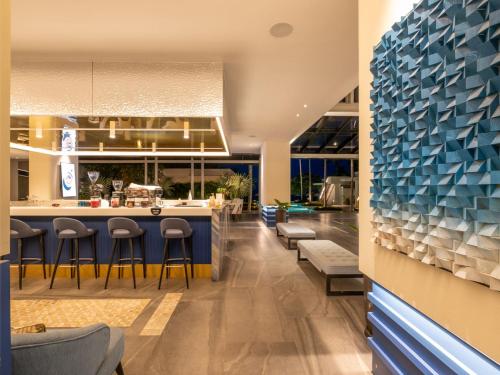 a restaurant with a blue counter and stools at RELO' The Urban Escape - Huahin in Cha Am