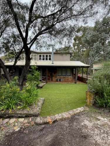 a large house with a grass yard in front of it at Bin 63 - Margaret River in Margaret River Town