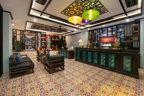 a lobby of a store with a bar and chairs at La Charm Hoi An Hotel & Spa in Hoi An