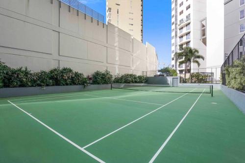 a tennis court in front of a building at Brisbane City Luxe 3-Bd, Views, Pool, Car park in Brisbane