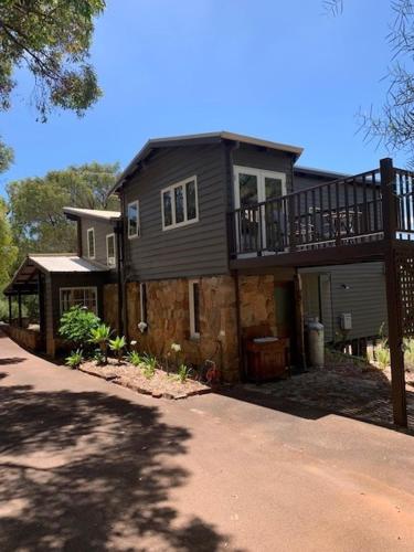 a large house with a balcony on top of it at Bin 63 - Margaret River in Margaret River Town
