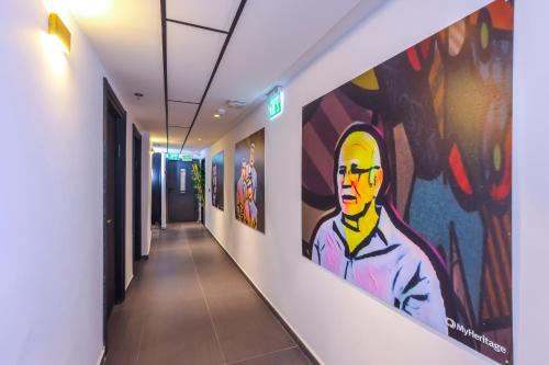 a hallway with paintings on the walls of a building at מלון בוטיק H34 in Nahariyya