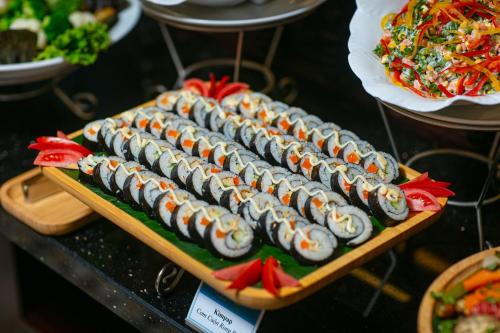 a bunch of sushi on a tray on a table at La Charm Hoi An Hotel & Spa in Hoi An