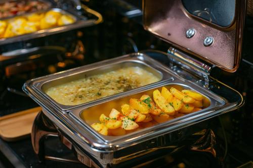 a tray of food in an oven with food at La Charm Hoi An Hotel & Spa in Hoi An