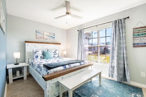 a bedroom with a bed and a window at Sea Breeze Retreat in Navarre