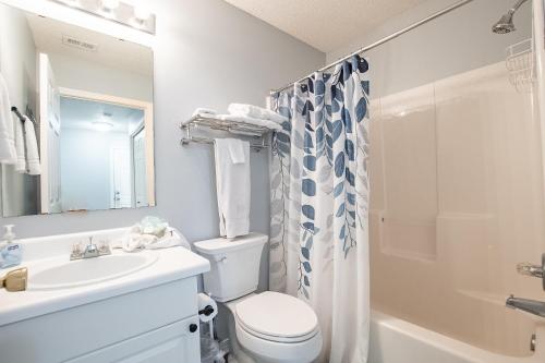 a bathroom with a sink and a toilet and a shower at Sea Breeze Retreat in Navarre
