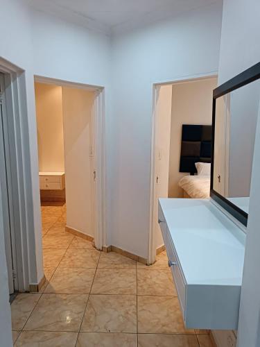 a room with a white counter and a bedroom at AFYZ Mansions in Lenasia
