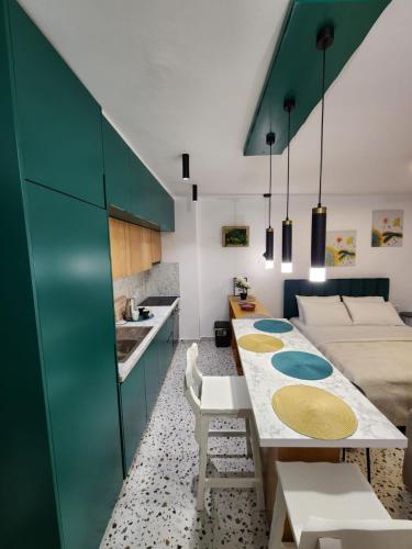 a kitchen and living room with a table and a couch at Pietro Guesthouse in Tirana