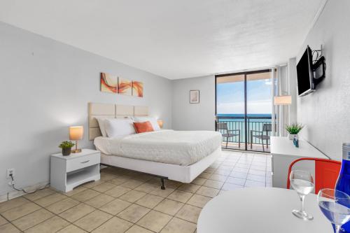 um quarto com uma cama e vista para o oceano em Romantic Oceanfront Studio Escape w Perfect View 1212 em Myrtle Beach