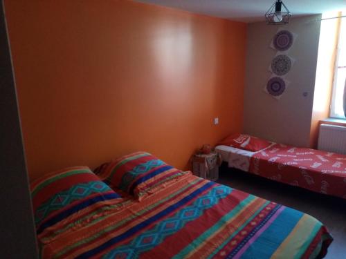 a bedroom with a bed and a window and a bedskirts at Nid douillet in Genilac