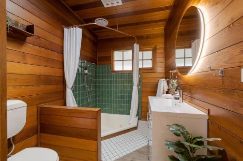 a bathroom with a toilet and a shower and a sink at Golden Pine Retreat in Bright