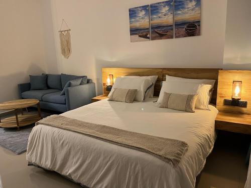 a bedroom with a large bed and a blue chair at Beachside Studio Retreat in Negombo