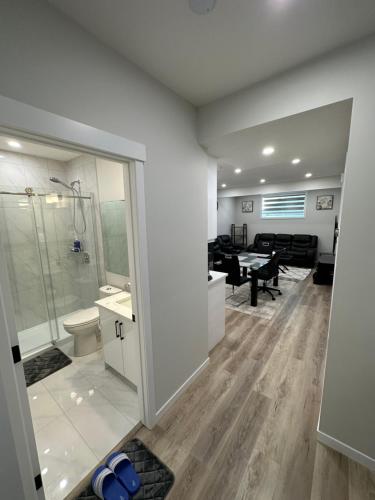 a bathroom with a shower and a sink and a toilet at 2 Bedroom 2 Washrooms Brand New Beautiful & Cozy Suite in Calgary