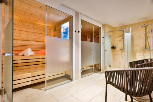 a glass shower in a bedroom with a bed at I LOVE SYLT Hotel Terminus ADULTS ONLY in Westerland