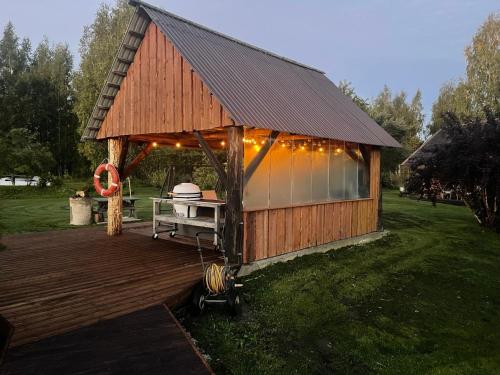 a gazebo with lights on it in a yard at Wiire old fishermans farmhouse and smoke sauna in Saulepa