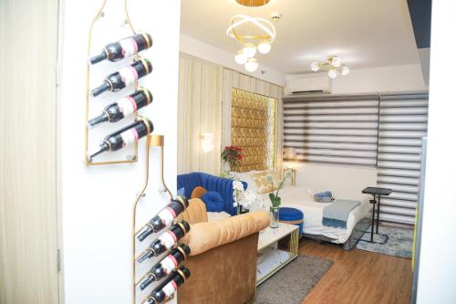 a living room filled with lots of wine bottles at Shore2 Luxurious & Homely Suite near MOA in Manila