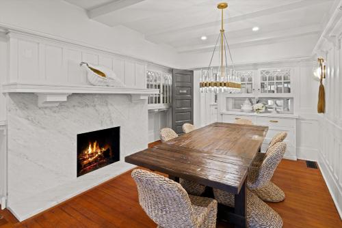 a kitchen with a wooden table and a fireplace at Montecito Hamptons Style Gated Resort - Steps from the Beach in Montecito