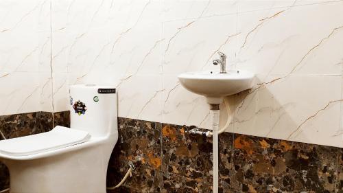 a bathroom with a toilet and a sink at HOTEL HELIX -- RAJPURA -- Budget Rooms for Family, Couples, Solo Travellers in Rājpura