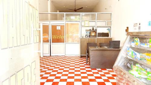a restaurant with a checkered floor and a counter at HOTEL HELIX -- RAJPURA -- Budget Rooms for Family, Couples, Solo Travellers in Rājpura