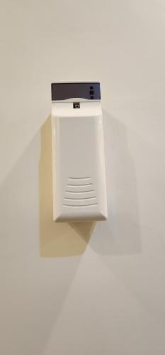 a white refrigerator sitting on top of a white wall at Red Fort Hotel Gulberg in Lahore