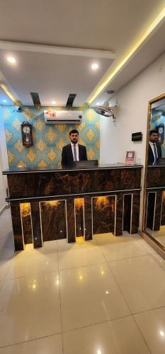 a man sitting at a bar in a room at Red Fort Hotel Gulberg in Lahore
