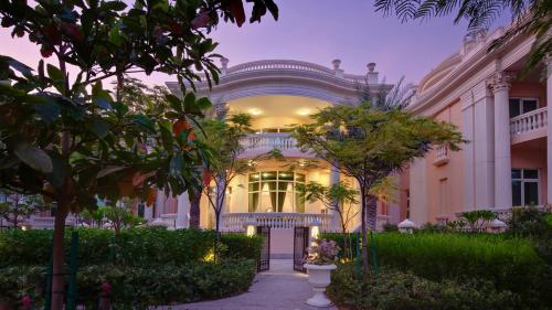 a large white building with trees in front of it at Kempinski Hotel & Residences Palm Jumeirah in Dubai