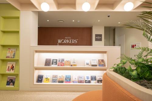 a display case in a book store with books at Workers Hotel Ansan by Aank in Ansan