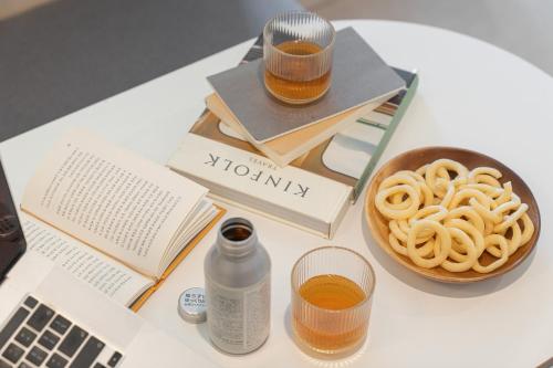 a table with a bottle of honey and a bowl of pasta at Workers Hotel Ansan by Aank in Ansan