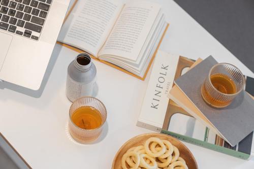 a table topped with a book and a plate of spaghetti at Workers Hotel Ansan by Aank in Ansan