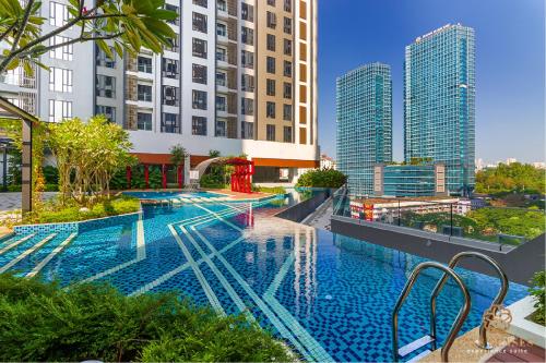 a large swimming pool on top of a building with tall buildings at Sentral Suites Kuala Lumpur, Five Senses in Kuala Lumpur