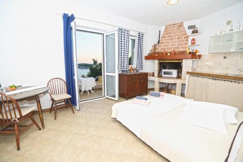a living room with a couch and a table and a dining room at Apartments Boćin Rosso in Hvar