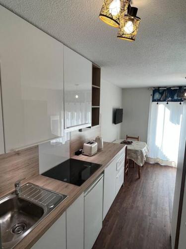 une cuisine avec un évier et un plan de travail dans l'établissement Studio rénové dans Saint-Lary, à Saint-Lary-Soulan