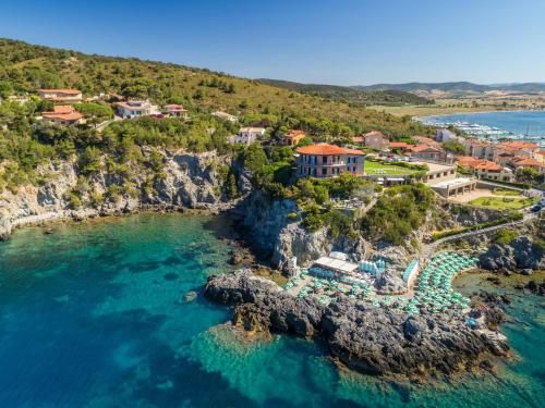 an aerial view of a resort on a rocky coast at Hotel Capo D'Uomo in Talamone