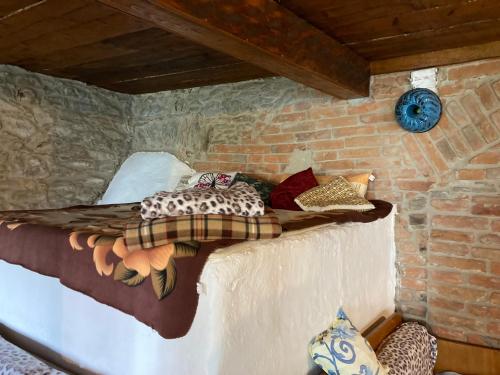 a bed in a room in a stone wall at Chalupa u Brčáků in Ktiš