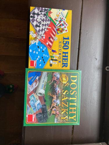 a game of monopoly is on top of a book at Chalupa u Brčáků in Ktiš
