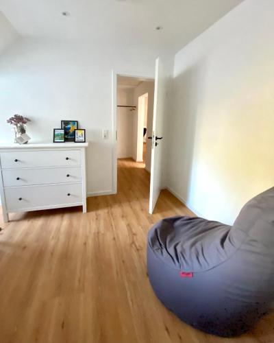 a bedroom with a bed and a dresser in a room at Harzpur Lodge - Pure Entspannung in purer Natur in Hahnenklee-Bockswiese