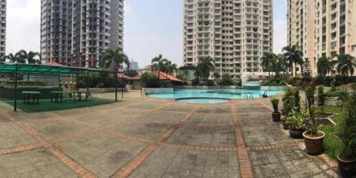 a courtyard with a pool in the middle of two tall buildings at lanai gurney corporate suites in Kuala Lumpur