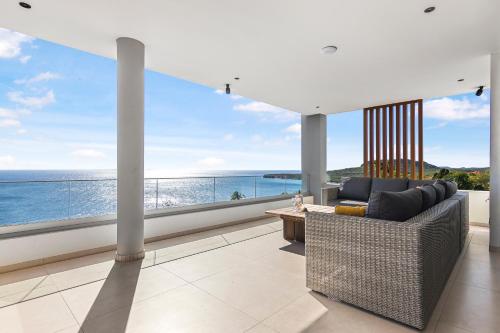 a living room with a view of the ocean at Luxury 12-Guest Villa in Gated Community with Pool, Ocean View & Private Beach Access in Willibrordus