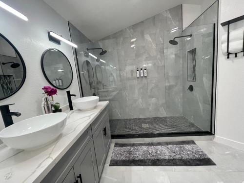 a white bathroom with a sink and a shower at 20percent OFF your next Luxury Home wt HEATED Pool-Spa & RVparking in Las Vegas