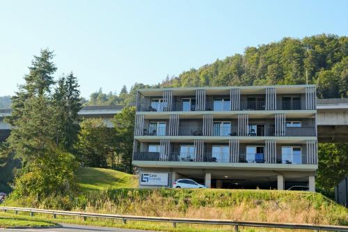 an apartment building with a car parked in front of it at Casa Grande in Techelsberg am Worthersee