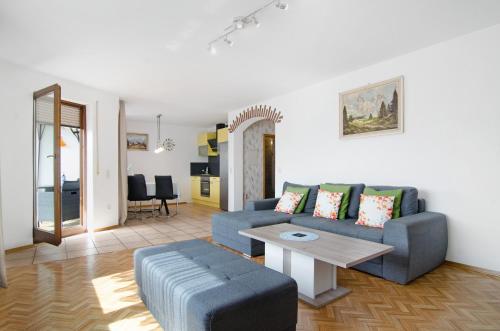 a living room with a couch and a table at Ferienwohnungen Sernatinger in Überlingen