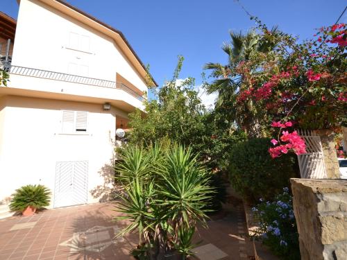 a house with flowers and plants in front of it at Simplistic Holiday Home in Sciacca near Horse Riding in Sciacca