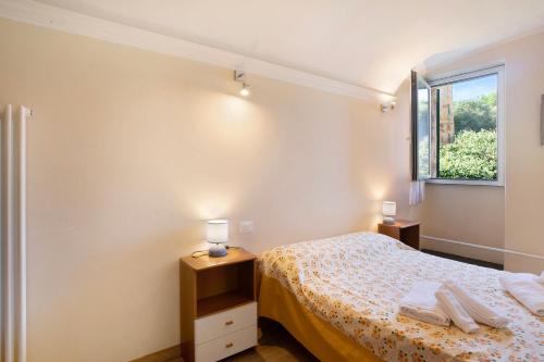 a small bedroom with a bed and a window at Ferrovia, borgo dei pescatori in Cervo