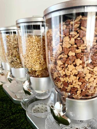 a row of food containers filled with nuts and cereal at Gasthof Kreischberg in Sankt Georgen ob Murau