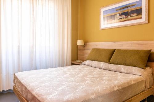 a bedroom with a bed and a painting on the wall at Park Hotel Residence in Orbetello