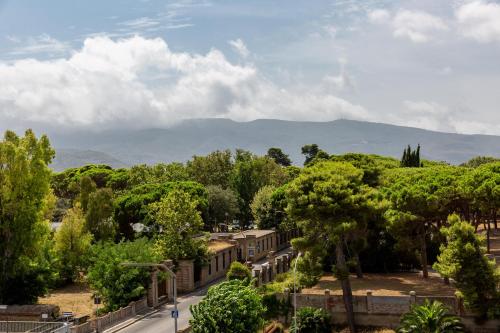 a view of a city with mountains in the background at Park Hotel Residence in Orbetello