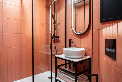 a bathroom with a sink and a shower at La Dépendance in Paris