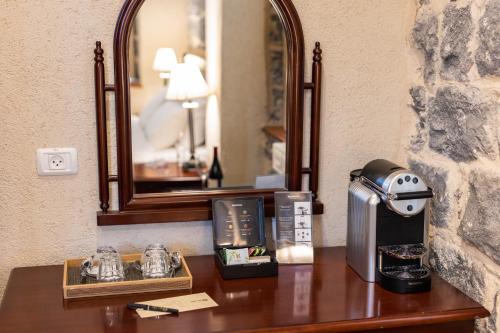 a wooden table with a mirror and a coffee maker on it at Europa 1917 in Tiberias