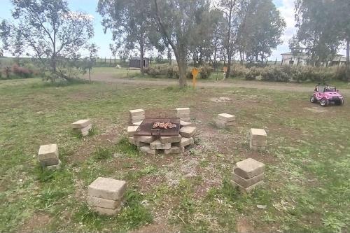 a fire pit in the middle of a field at Agri Homes Spanora in Crocicchie